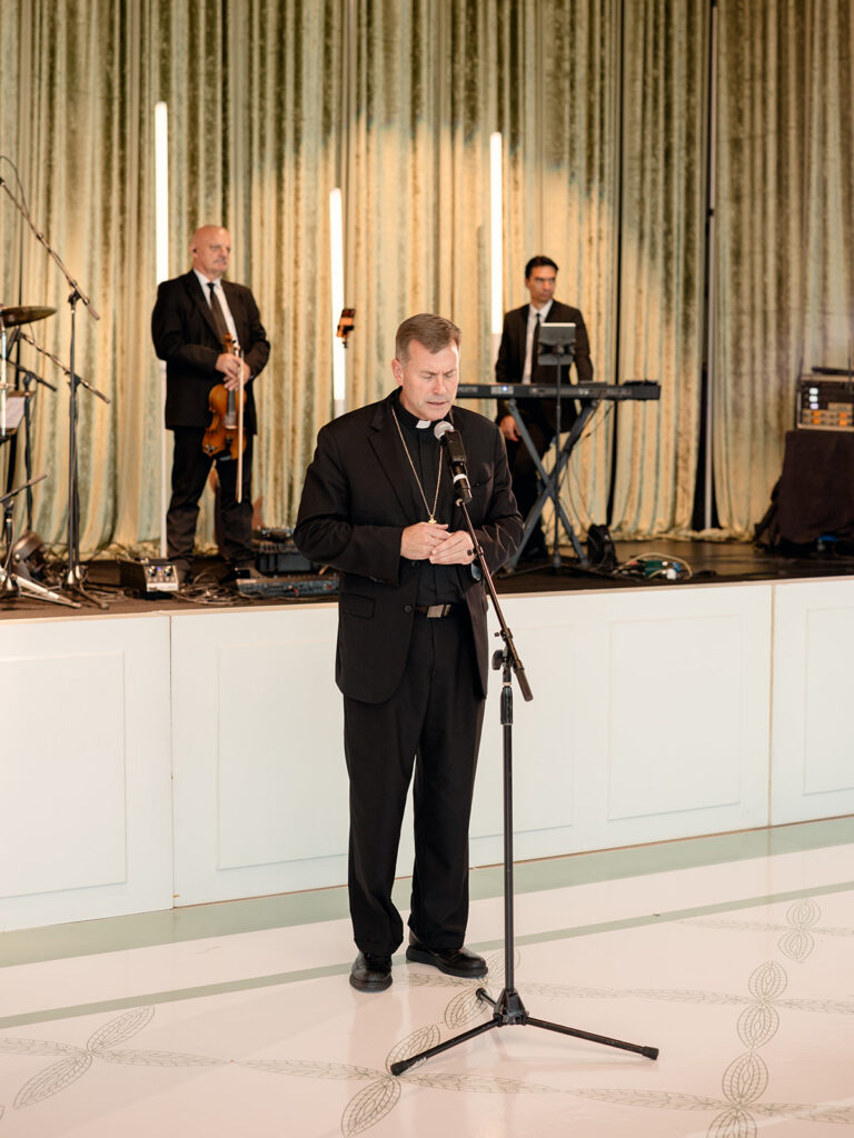 Priest leading the blessing at the reception