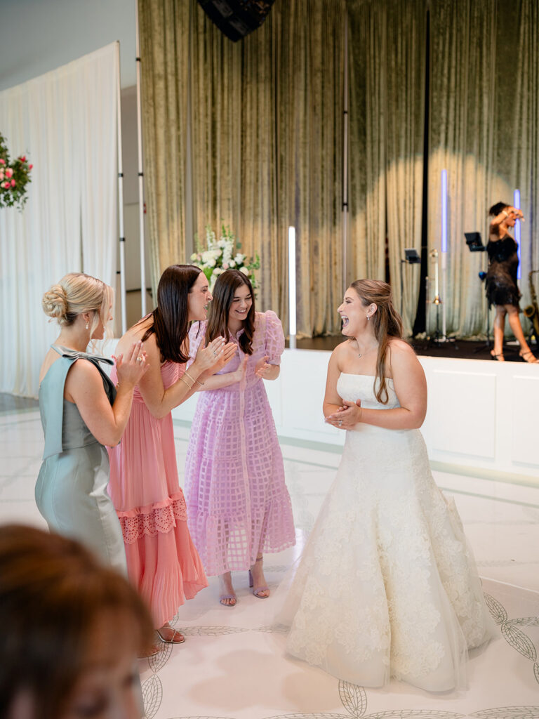 Bride dancing with friends in front of the live band