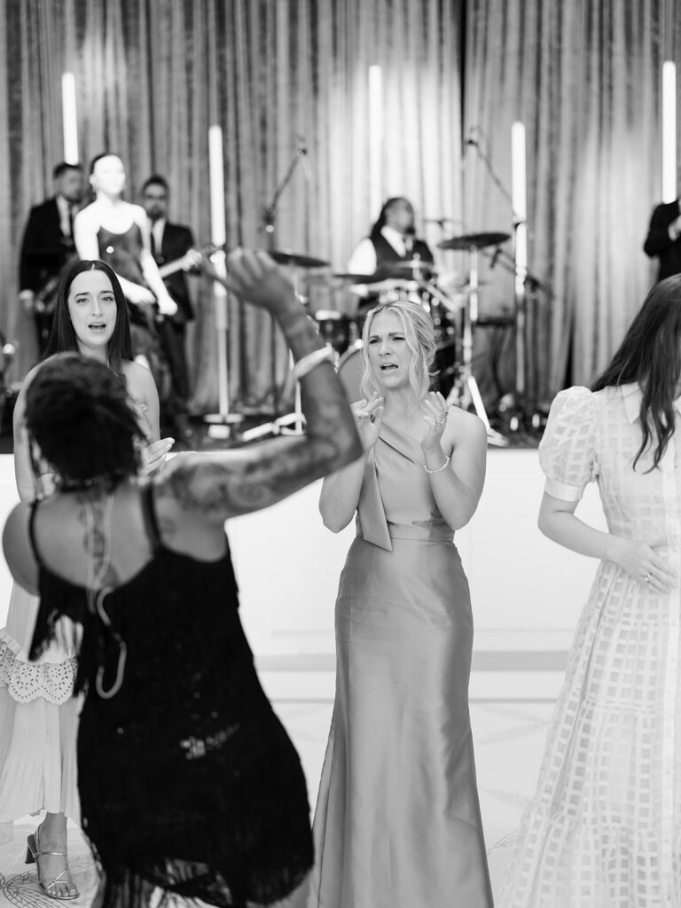 Black and white photo of guests dancing with the band singer