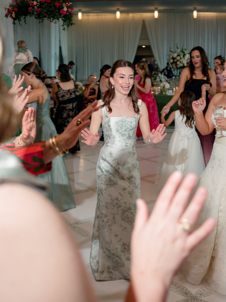 Bridesmaid in a toile gown dancing at the reception